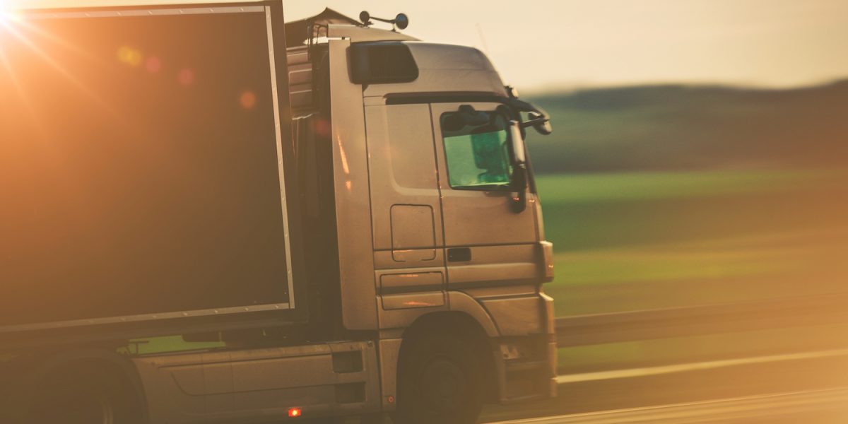 Road Transportation by Truck Concept Photo. Speeding Euro Truck on the European Highway.